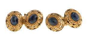 
	
		A pair of sapphire cufflinks, each oval link centring on a cabochon sapphire to an open...