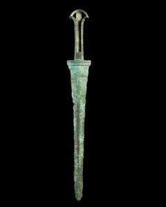A Luristan bronze flange-hilted dagger,circa 10th-8th Century B.C.,
with semi-circular...