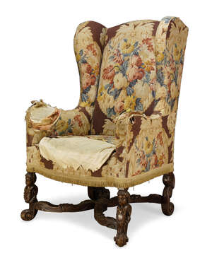 
	
		A William and Mary style wingback armchair, first half 20th century, the serpentine back...