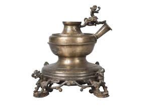 
	
		A Nepalese brass lamp base, 19th century, surmounted with a winged dragon and cast with...