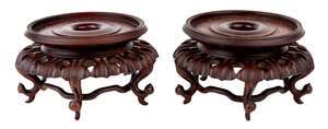 
	
		A pair of Chinese hardwood stands, 19th century, each carved with sinuating feet...