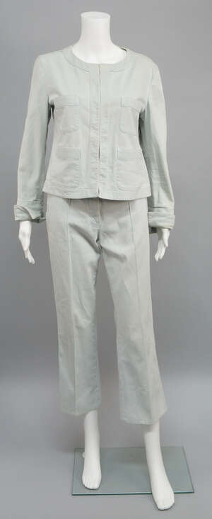 
	
		Chanel: an ice blue cotton trouser suit, the collarless jacket with edge to edge...