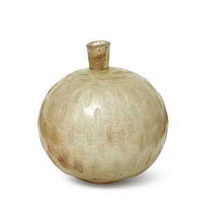 
	
		A Sassanian wheel cut green glass bottle,  
		6th-7th century, of globular form with...