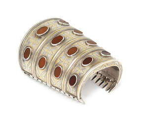 
	
		A large silver and brass single Turkoman Tekke cuff, of tapering form, with triangular...