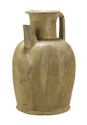 A Chinese Changsha ewer, Tang dynasty, 9th century, covered in a pale olive green glaze, with lobed body, faceted spout, and applied loop handle, moulded with 