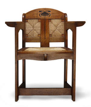 
	
		E.G. Punnett (British), and Art & Crafts inlaid oak and rush  seated arm chair made by...