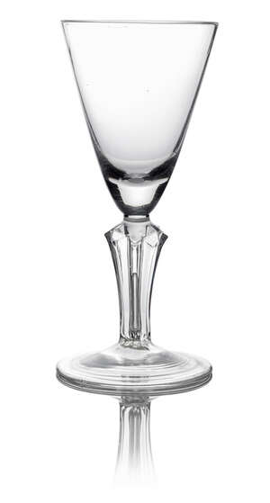 A George I pointed funnel goblet, c. 1720, with pedestal stem decorated with alternate stars, on conical folded foot, 21cm high