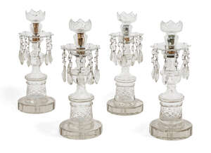 
	
		A set of four Regency clear cut-glass candlesticks, with crenulated sconces and teardrop...
