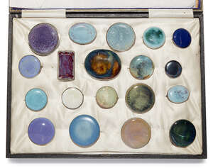 
	
		Ruskin Pottery (1898-1935), a collection of Nineteen ceramic brooches with silver and...