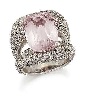 A kunzite and diamond ring, the cushion shaped kunzite mounted within pavé brilliant-cut diamond tapered sides, one diamond deficient, ring size N