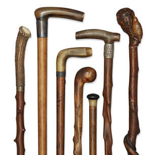 
	
		A collection of seven various briar, horn and antler walking canes, early-mid 20th...