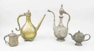 
	
		An Indian brass ewer, 18th century, with elongated straight spout and curving handle, the...