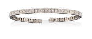 
	
		A diamond bangle, of sprung open half-hoop design, the front set with a line of...