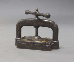 
	
		A large lacquered and gilt metal book press, late 19th/early 20th century, 51cm wide

	


