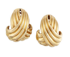 
	
		A pair of crossover ear clips, by Hermes, designed as rounded, reeded arcs to clasp...