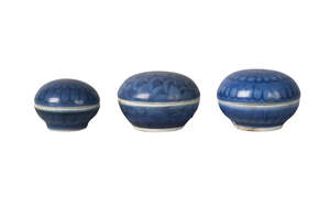 Three Chinese porcelain circular seal paste boxes and covers, 18th century, painted in underglaze blue with flowerheads, 4cm-5cm
		 
		Provenance: Private L