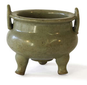 A Chinese Longquan celadon tripod censer, Ming dynasty, imitating bronze examples, with loop handles and bellied body, unglazed circular base, 13cm diameter
