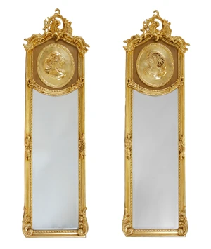 A pair of French giltwood wall mirrors, second quarter 20th century, the Baroque-style c-scroll...