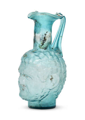
	
		A very large Roman-style mould-blown blue glass head vase, 20th century or earlier, the...
