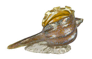 
	
		Loetz, an iridescent glass vase of shell form
		c.1900
		The yellow body of the shell...