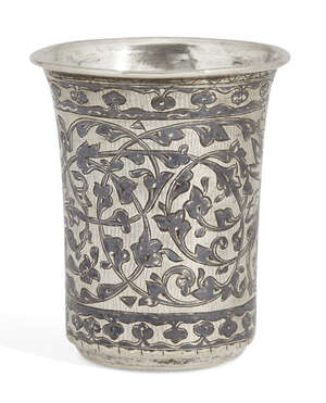 
	
		A white metal niello decorated beaker, spurious marks, decorated with foliate patterns...