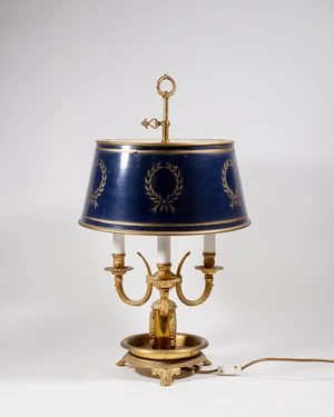 A French brass three-light bouillotte lamp, 20th century, the base raised on three foliate feet,...