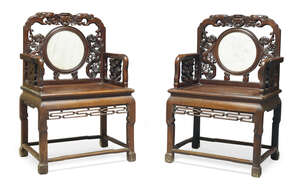 
	
		A pair of Chinese hardwood armchairs, 19th century, the carved backs set with circular...