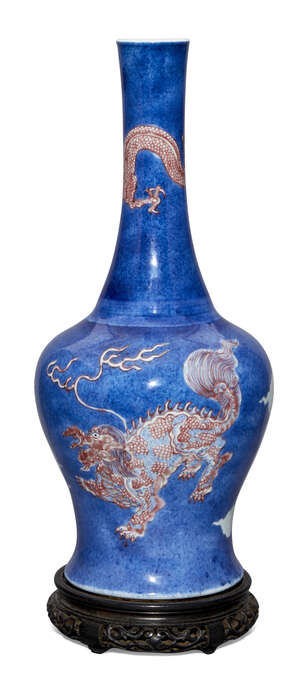A rare Chinese porcelain powder blue ground bottle vase, Kangxi period, painted in underglaze blue and copper red with a dragon to the slender neck and two myt