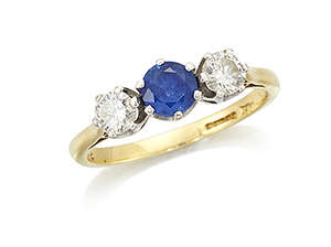 
	
		An 18ct gold, sapphire and diamond three stone ring, the circular-cut sapphire in...