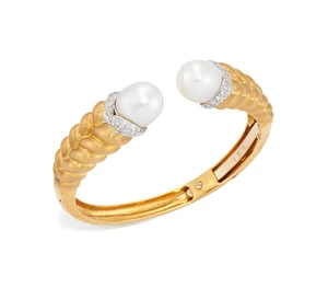 A cultured pearl and diamond torque bangle, the terminals set with a South Sea cultured pearl,...