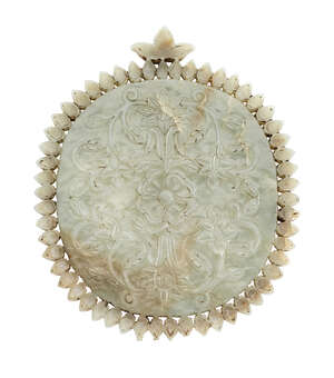 
	
		A Mughal jade mirror, India, 18th century, of oval form, with leaf-shaped handle, and...