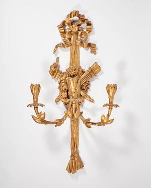 A Louis XVI style giltwood three branch wall light, 20th century, the backplate with ribbon-tie...