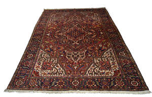 
	
		A Heriz carpet, mid 20th Century, with pole medallion in a deep red field, with ivory...