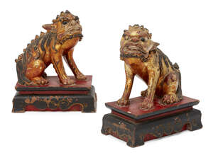 
	
		A pair of Chinese gilt lion dogs, early 20th century, modelled seated on a wood base,...