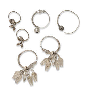 
	
		Three pairs of Omani silver earrings and nose rings, 20th century, of hoop shape (6)...