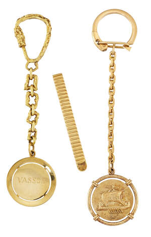Two keyrings and a tie clip, one keyring of abstract link design suspending a circular fob with engraved name, the second of belcher link design, the circular 