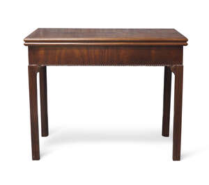 
	
		A George III mahogany fold over tea table, the beaded border with scroll motifs, hidden...
