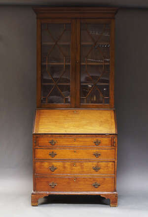 
	
		A George III mahogany bureau bookcase, the later top section with moulded cornice above...