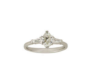 
	
		A fancy-cut diamond single stone ring, the cut cornered navette-cut diamond weighing...