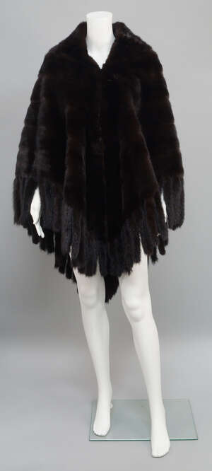 
	
		A mahogany mink open fronted poncho, trimmed with seventy-four mink tails, unlabelled,...