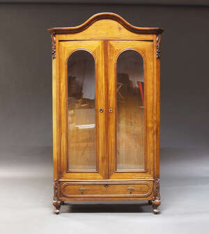 
	
		A Victorian mahogany bookcase the arched cornice, above two glazed cupboard doors,...