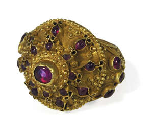 
	
		A Thai gold filigree decorated ring, 19th century, set with ruby coloured paste gems

	

