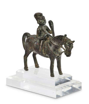 A Parthian bronze horserider, 2nd century B.C.2nd century A.D., shown holding a staff, 10cm high x 10.5cm wide.
		 
		Provenance: Acquired in 2002, Boisgira