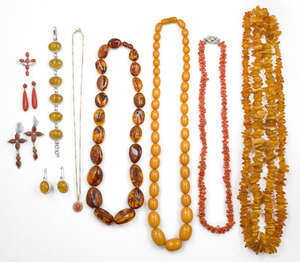A group of jewellery, comprising: a 9ct gold necklace suspending a cabochon coral pendant; a pair of coral drops; a pair of coral cruciform design earrings and