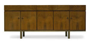 
	
		A rosewood sideboard, retailed by Heals  
		c.1960  
		With five frieze drawers, two...