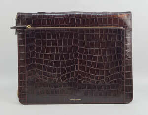 An Aspinal of London brown leather crocodile effect briefcase, with zip closure, suede and...