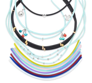 A group of five rubber necklaces, in black or pale blue rubber of square or round section, some...