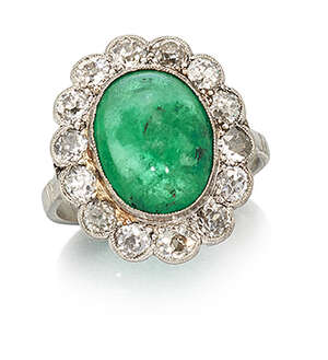 
	
		A platinum, emerald and diamond cluster ring, the single collet-set cabochon emerald with...