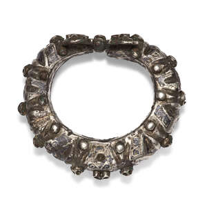 
	
		A Seljuk silver and niello cuff bracelet, Iran, 12th century, of thick, curved form, the...
