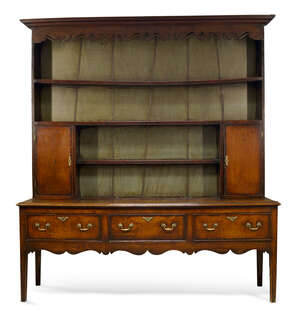 
	
		A George III oak dresser, the plate rack with moulded cornice over shaped and pierced...